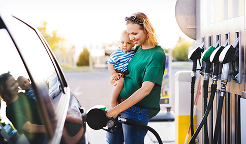 Young,Mother,With,Baby,Boy,At,The,Petrol,Station.